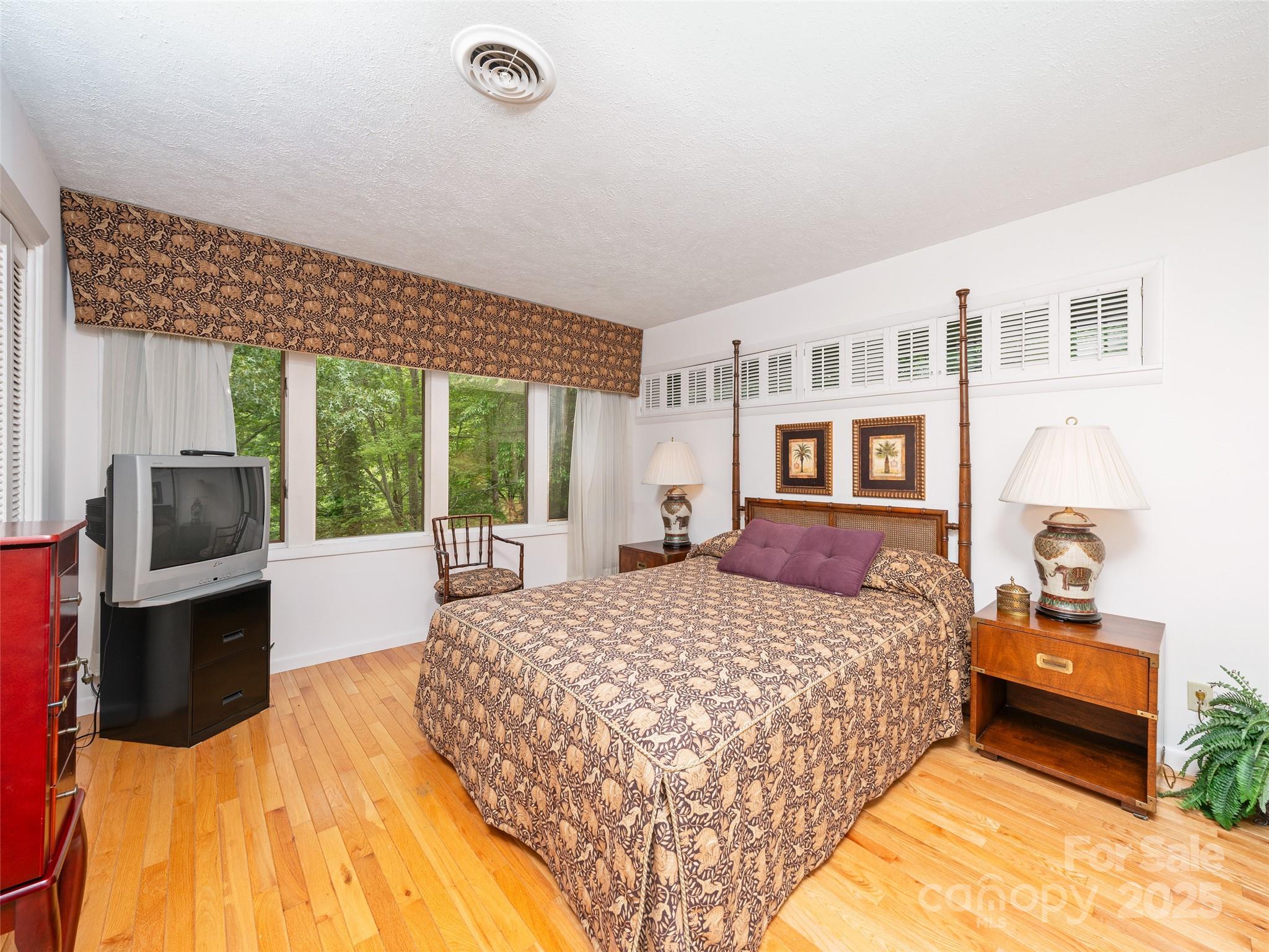 59 Deer Place Road Spruce Pine, NC 28777 - Photo 15 of 40 a bedroom with a bed and wooden floor