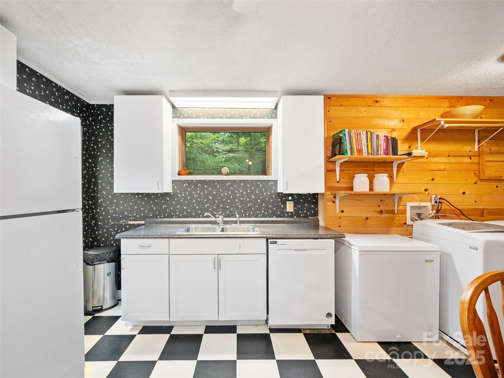 59 Deer Place Road Spruce Pine, NC 28777 - Photo 20 of 40 a kitchen with a stove a sink and a refrigerator