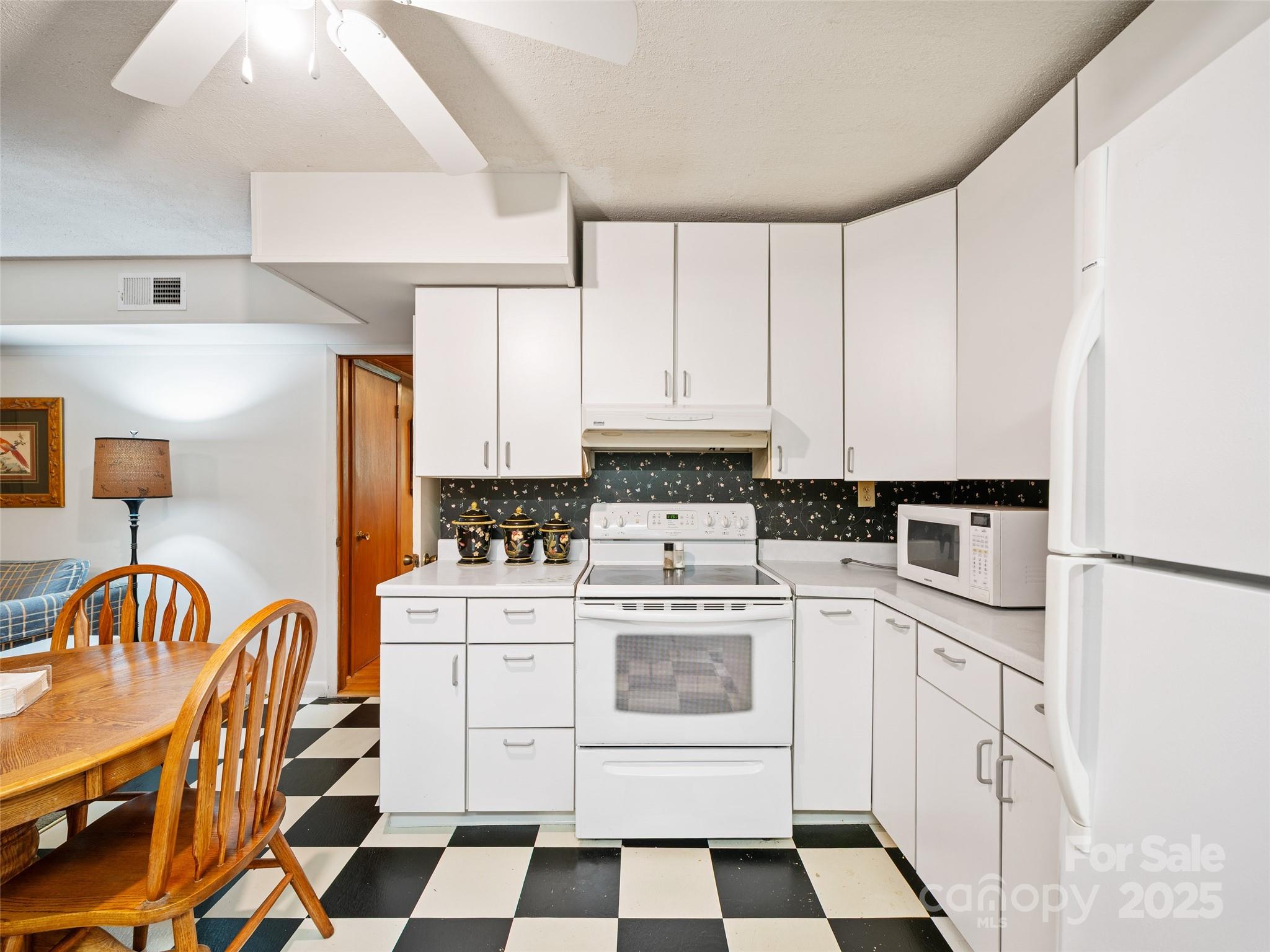 59 Deer Place Road Spruce Pine, NC 28777 - Photo 21 of 40 a kitchen with stainless steel appliances a stove a sink and a refrigerator