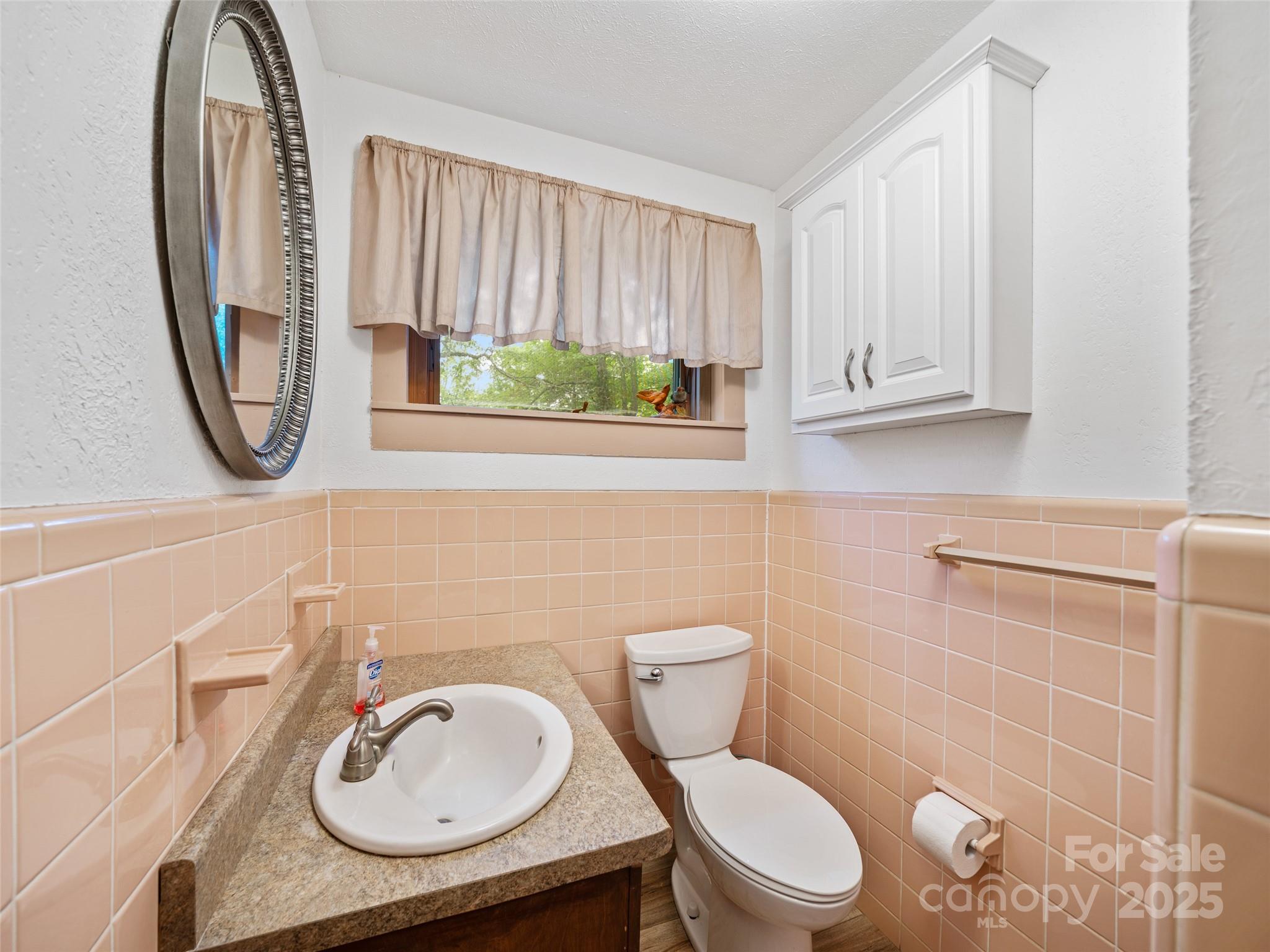 59 Deer Place Road Spruce Pine, NC 28777 - Photo 24 of 40 a bathroom with a sink a toilet and a mirror