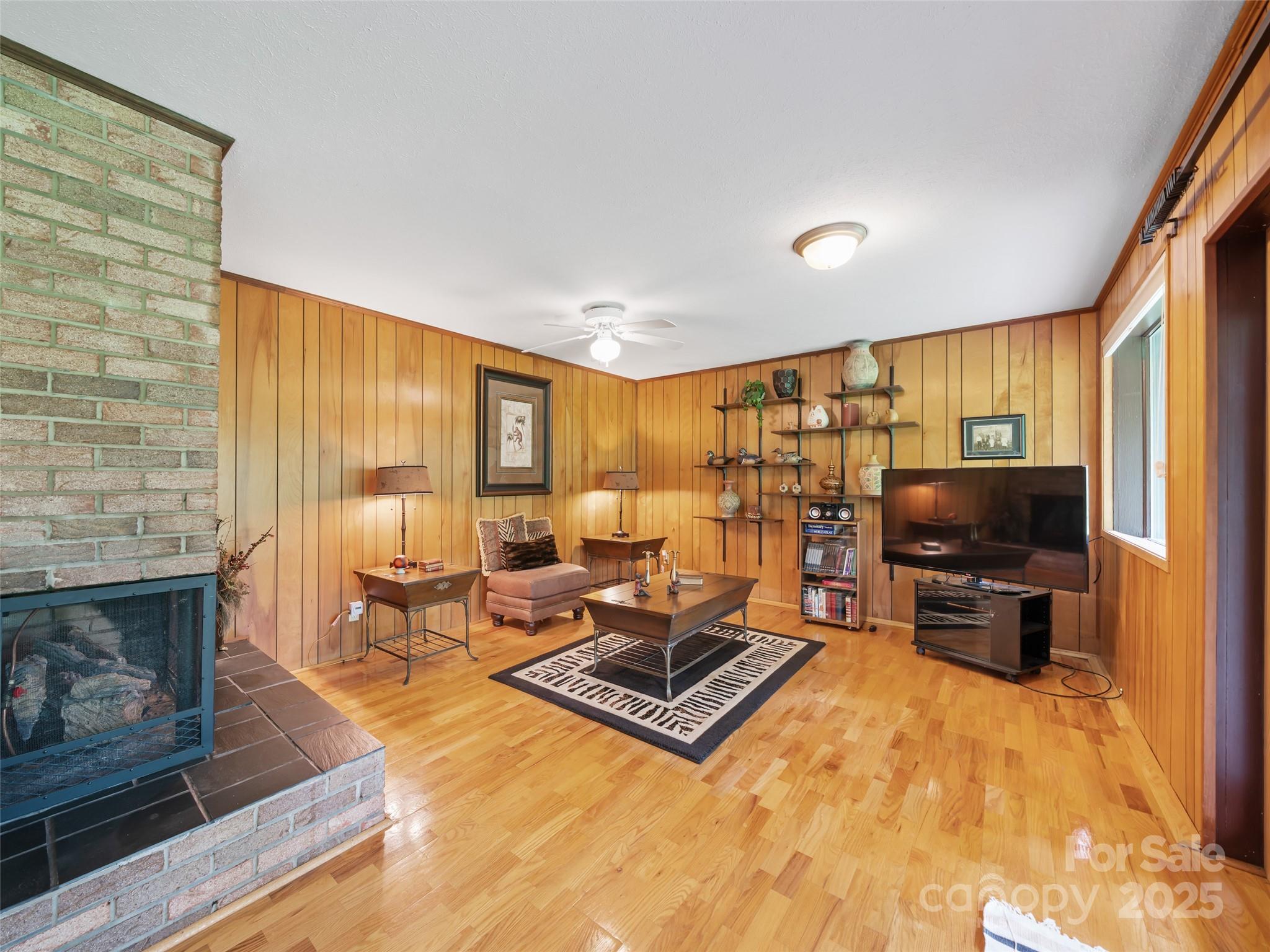 59 Deer Place Road Spruce Pine, NC 28777 - Photo 26 of 40 a living room with furniture flat screen tv and a fireplace