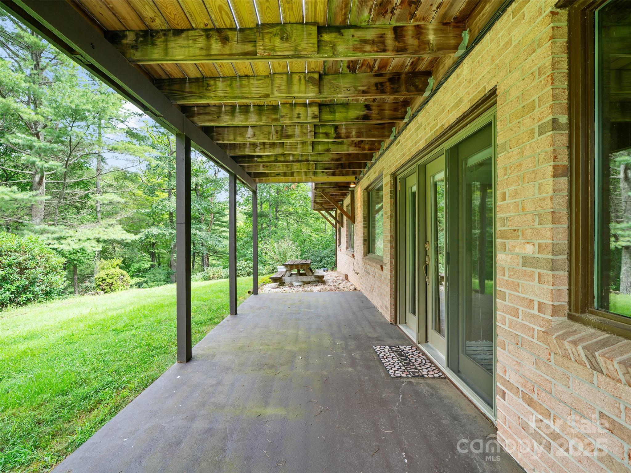 59 Deer Place Road Spruce Pine, NC 28777 - Photo 28 of 40 a view of a porch with wooden floor and roof