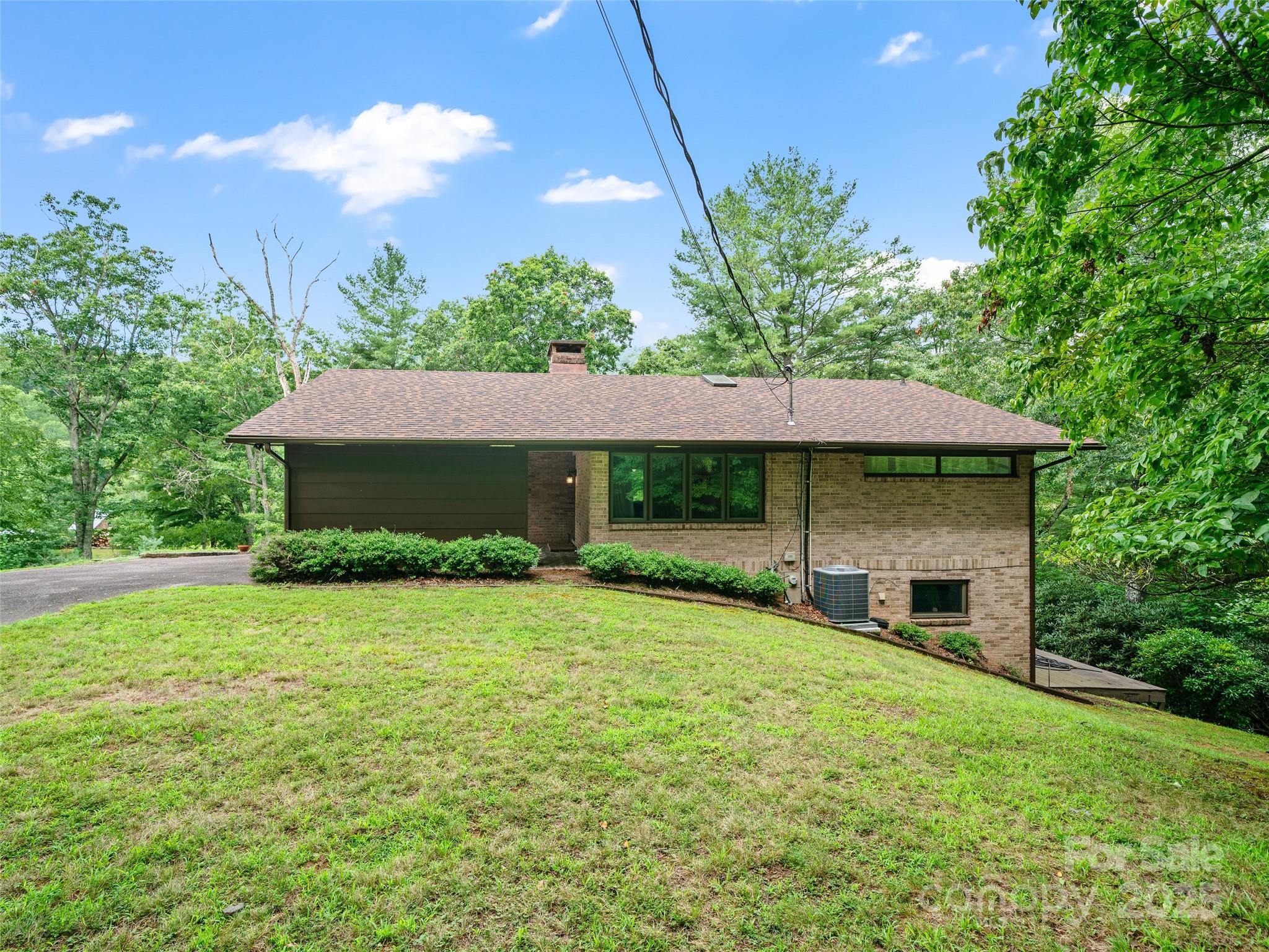 59 Deer Place Road Spruce Pine, NC 28777 - Photo 30 of 40 a front view of a house with garden