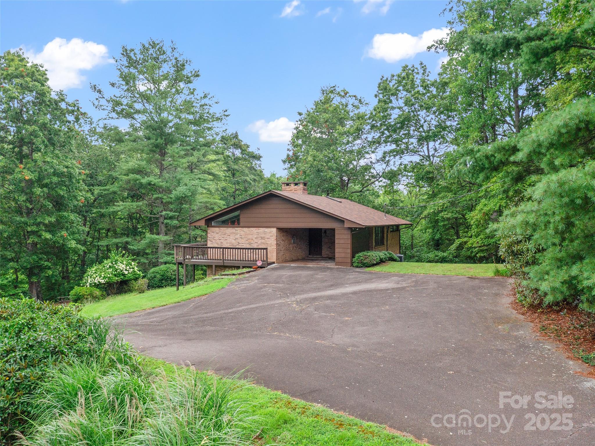 59 Deer Place Road Spruce Pine, NC 28777 - Photo 33 of 40 a view of a house with a yard and large tree