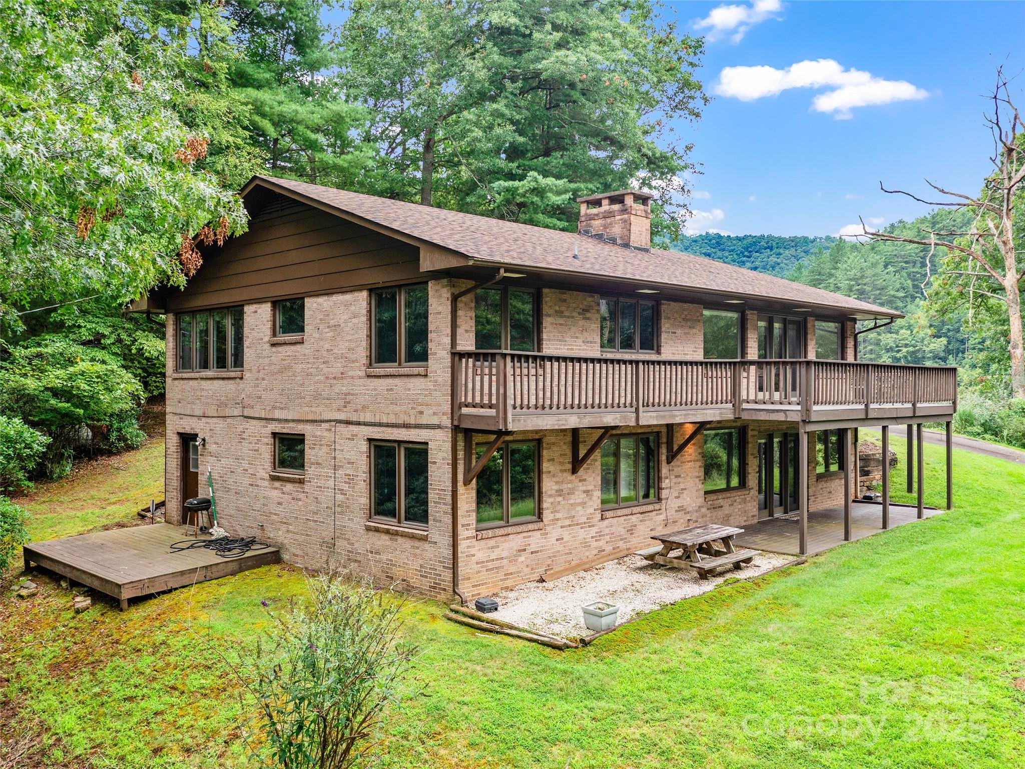 59 Deer Place Road Spruce Pine, NC 28777 - Photo 35 of 40 a view of a house with a yard porch and sitting area