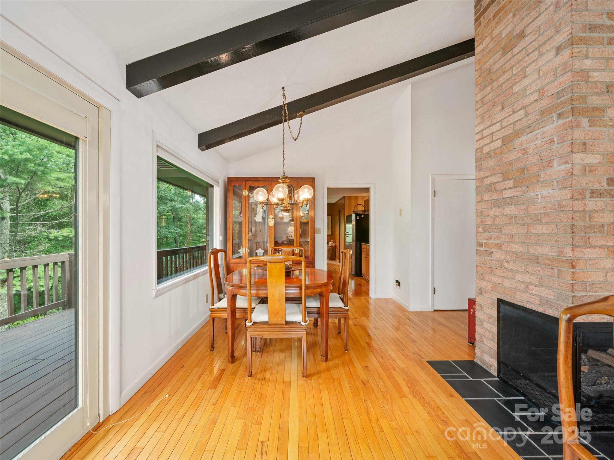 59 Deer Place Road Spruce Pine, NC 28777 - Photo 6 of 40 a view of a dining room with furniture wooden floor and a fireplace