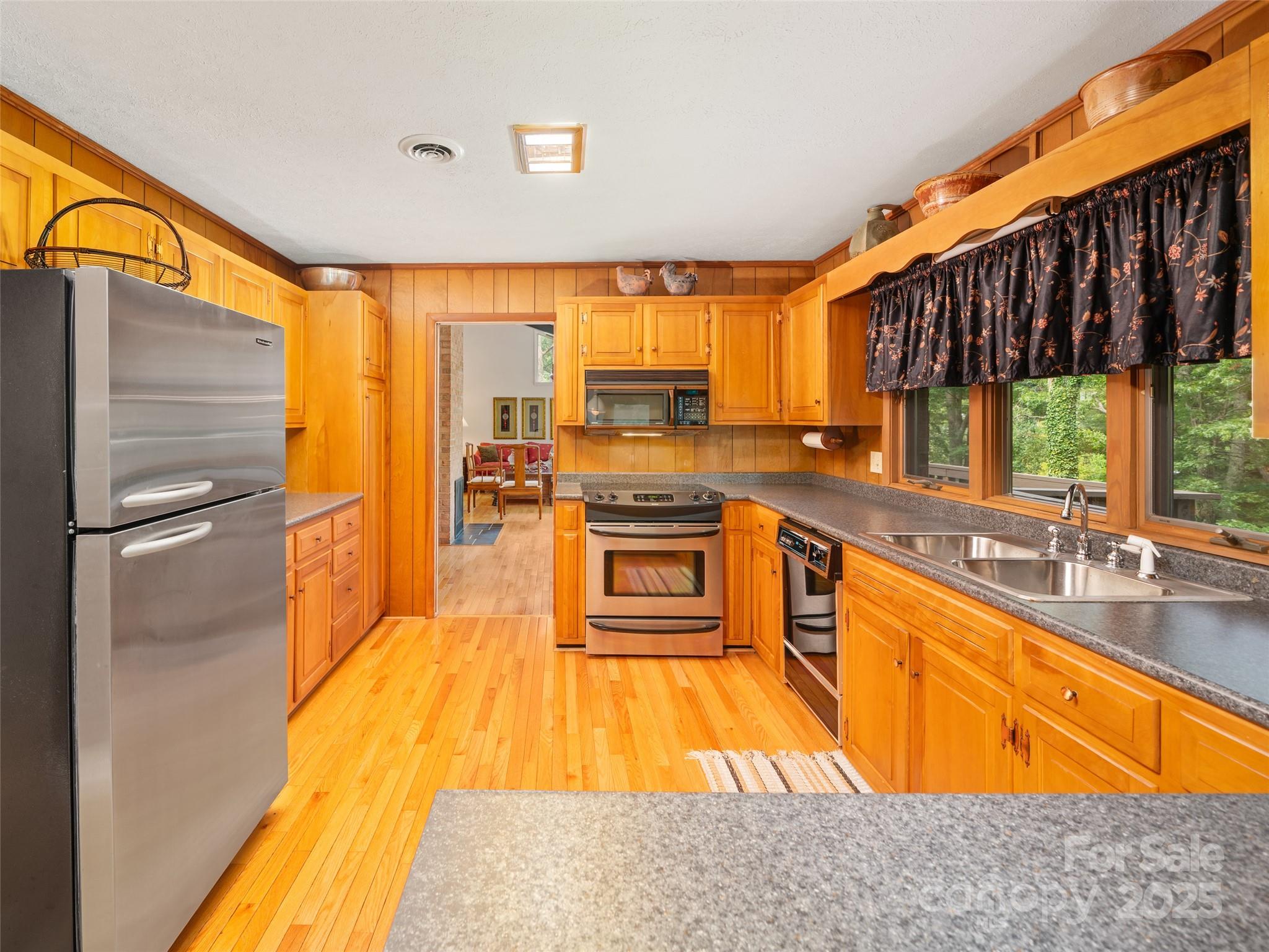 59 Deer Place Road Spruce Pine, NC 28777 - Photo 7 of 40 a kitchen with stainless steel appliances granite countertop a sink a stove and a refrigerator