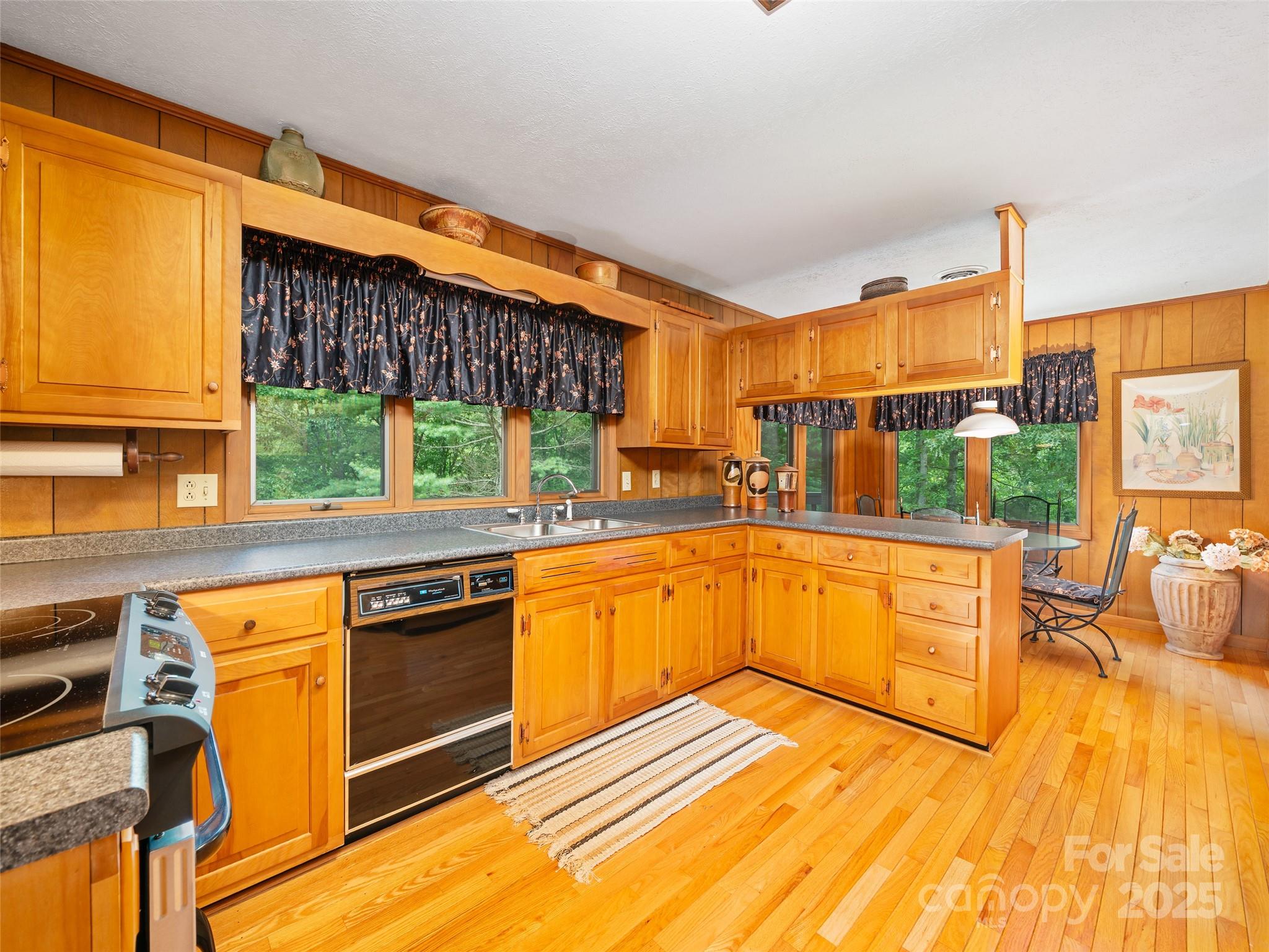 59 Deer Place Road Spruce Pine, NC 28777 - Photo 8 of 40 a kitchen with stainless steel appliances granite countertop a stove a sink and a microwave
