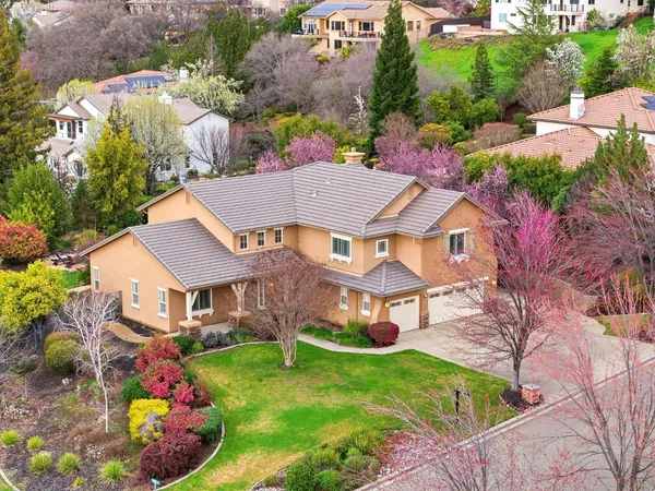 an aerial view of a house with a swimming pool yard and outdoor seating