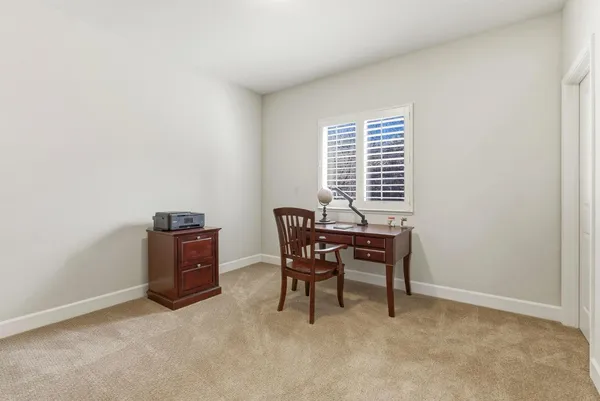 a bedroom with a bed and a ceiling fan