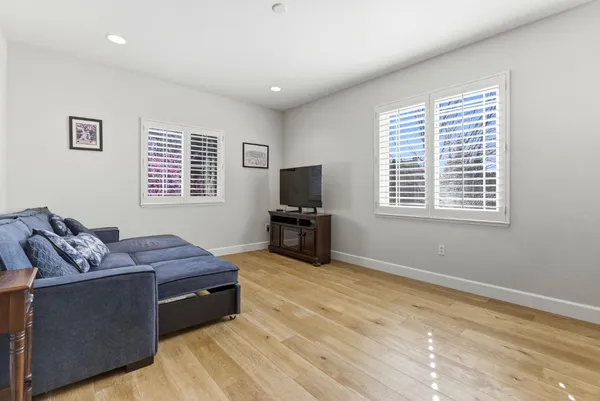 a bedroom with a large bed and a chandelier