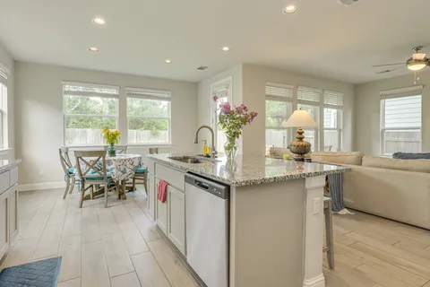 a kitchen with stainless steel appliances granite countertop a sink and a refrigerator