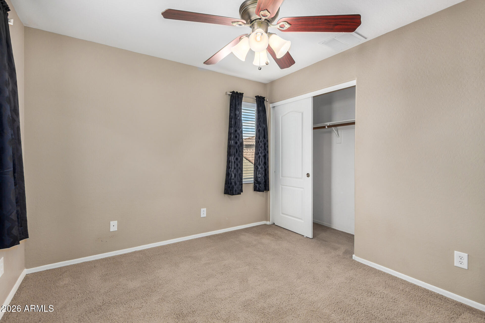 1784 South Seton Avenue Gilbert, AZ 85295 - Photo 16 of 27 an empty room with windows and fan