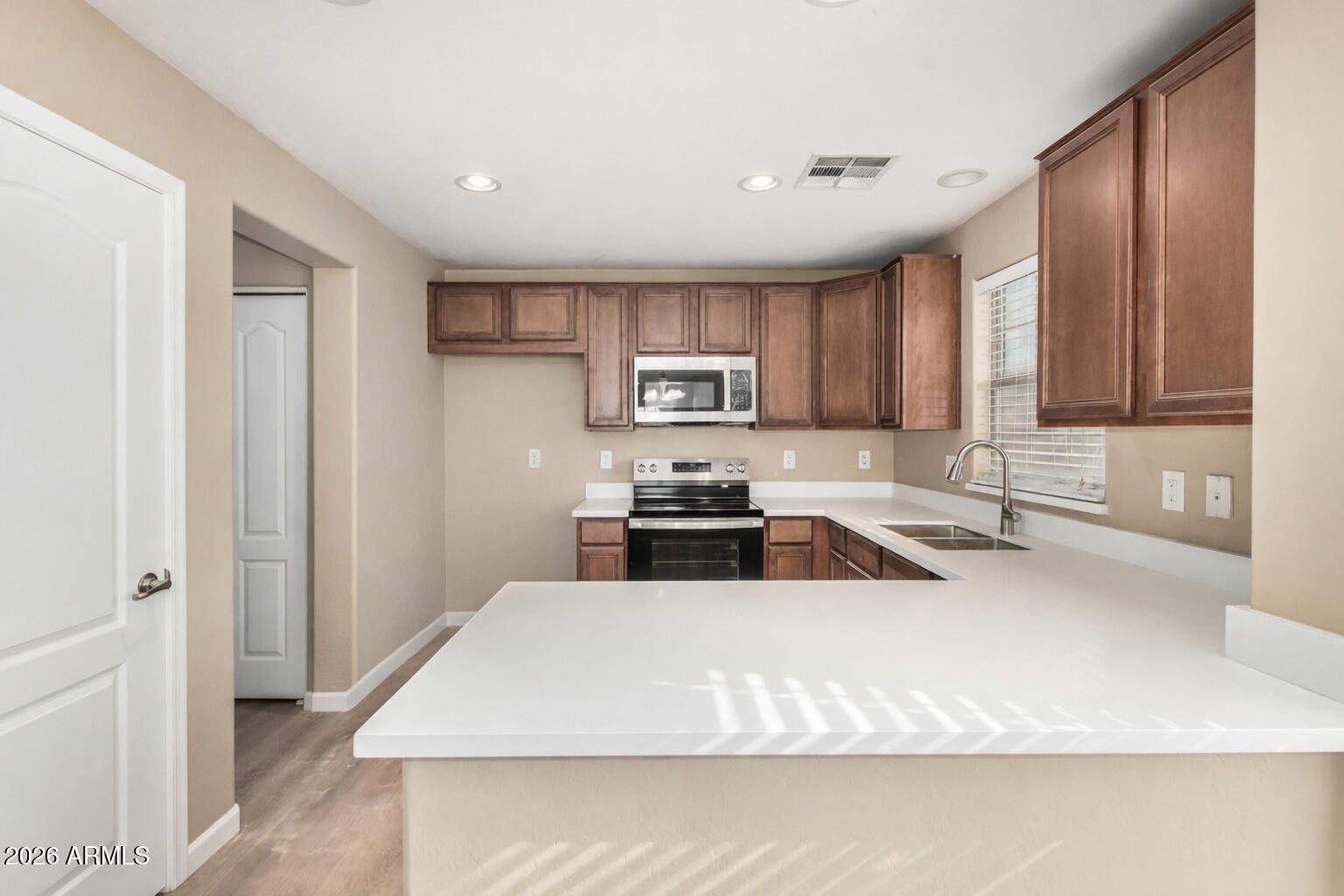 1784 South Seton Avenue Gilbert, AZ 85295 - Photo 3 of 27 a kitchen with a refrigerator sink and cabinets