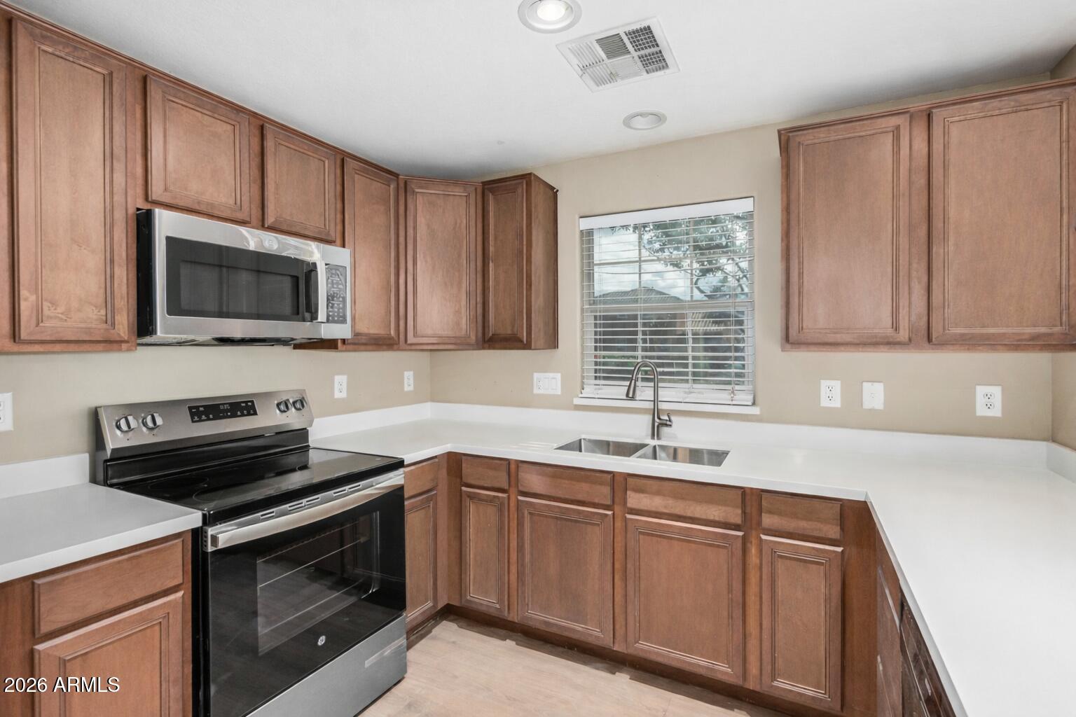 1784 South Seton Avenue Gilbert, AZ 85295 - Photo 4 of 27 a kitchen with a sink stove and microwave