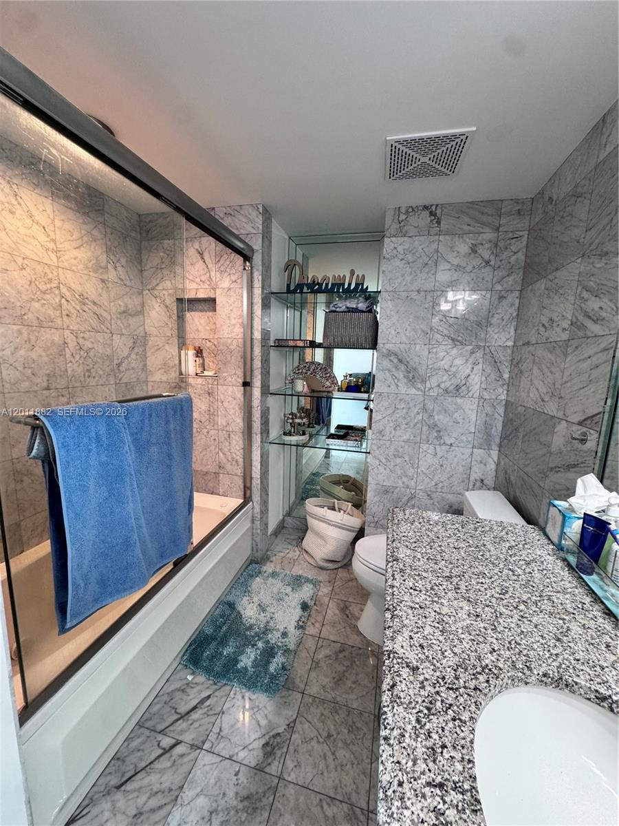 2101 Brickell Avenue, Unit 3205 Miami, FL 33129 - Photo 16 of 31 a bathroom with a sink toilet and shower