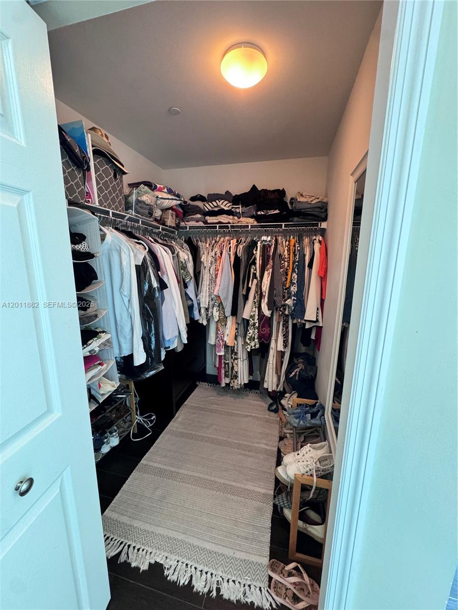 2101 Brickell Avenue, Unit 3205 Miami, FL 33129 - Photo 19 of 31 a view of walk in closet with clothes and shoes