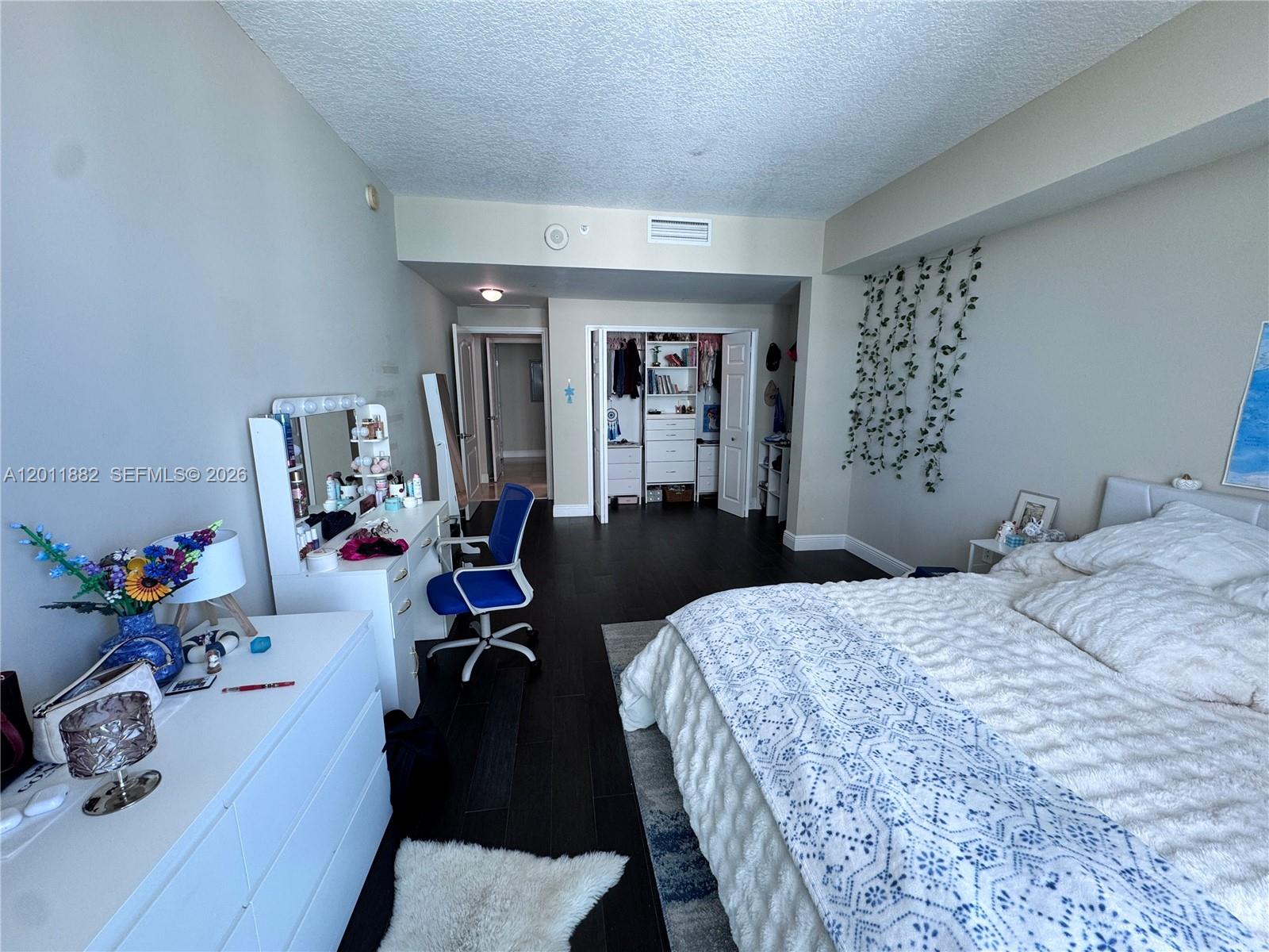2101 Brickell Avenue, Unit 3205 Miami, FL 33129 - Photo 23 of 31 a bedroom with a bed and wooden floor
