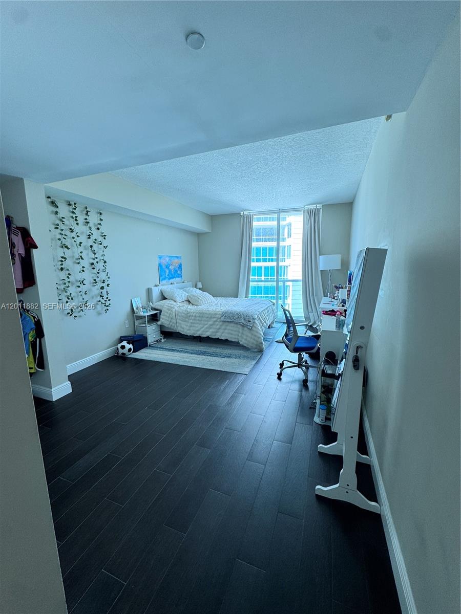2101 Brickell Avenue, Unit 3205 Miami, FL 33129 - Photo 25 of 31 a living room with furniture and a wooden floor