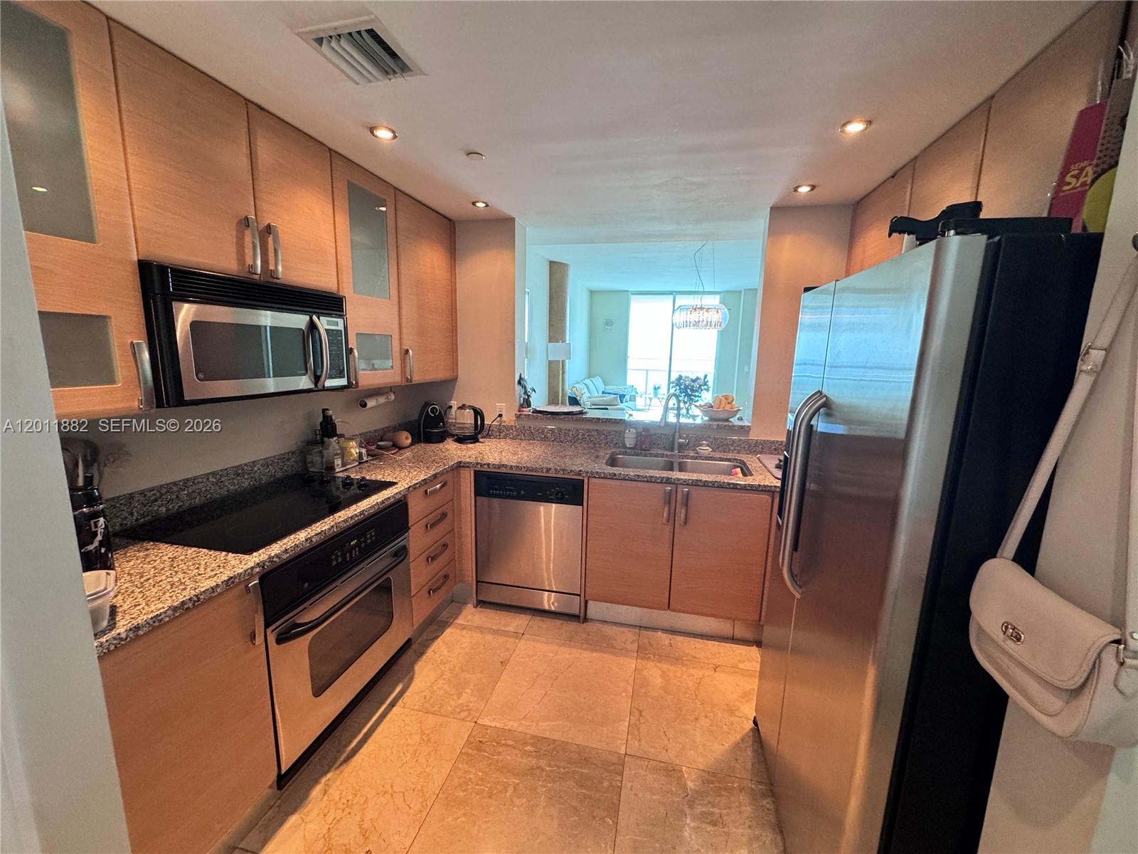 2101 Brickell Avenue, Unit 3205 Miami, FL 33129 - Photo 6 of 31 a kitchen with stainless steel appliances granite countertop a sink stove and refrigerator