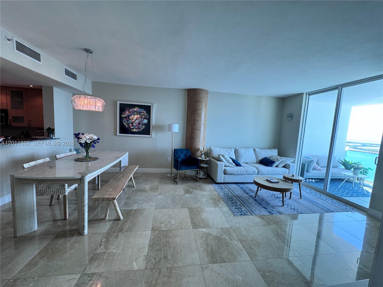 2101 Brickell Avenue, Unit 3205 Miami, FL 33129 - Photo 7 of 31 a living room with furniture a large window and a table