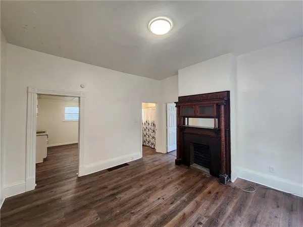 wooden floor fireplace and natural light in room