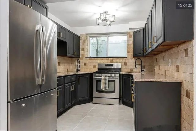a kitchen with stainless steel appliances a refrigerator stove and sink