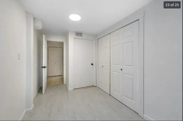 a view of an empty room and closet area
