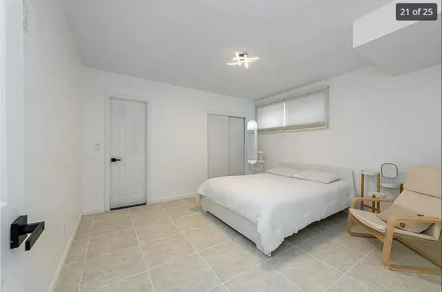 a bedroom with a bed and chair