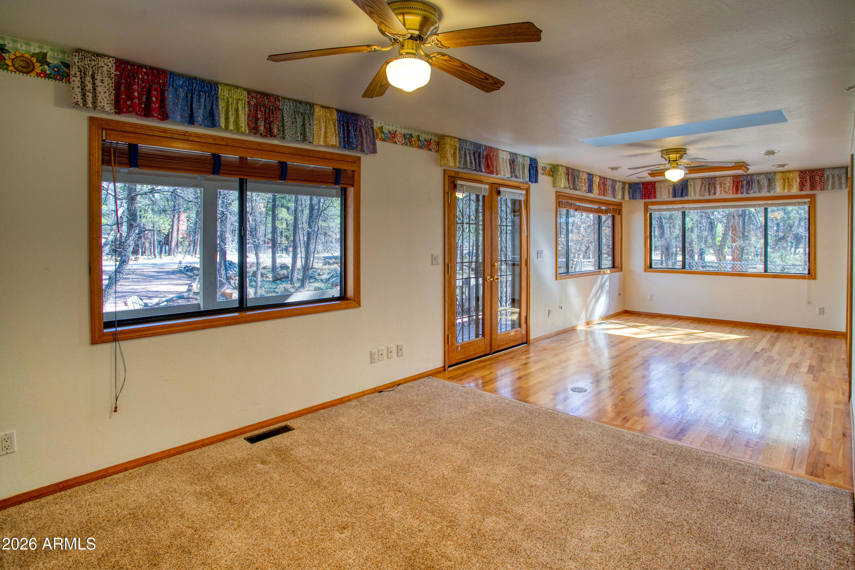 71 East Turkey Track Lane Pinetop, AZ 85935 - Photo 17 of 50 a view of an empty room with a window and wooden floor