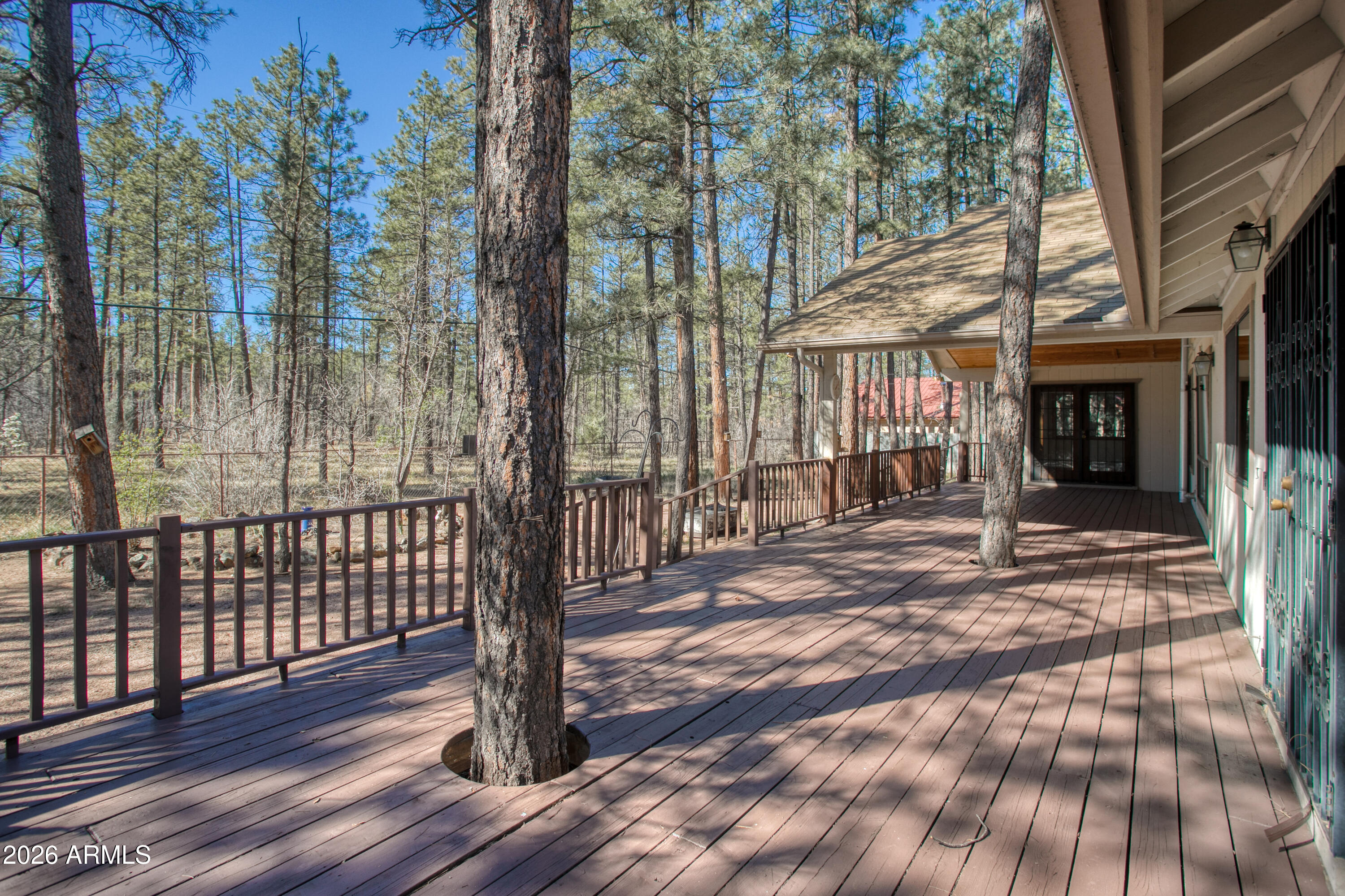 71 East Turkey Track Lane Pinetop, AZ 85935 - Photo 27 of 50 a view of a porch with a floor to ceiling window with wooden fence