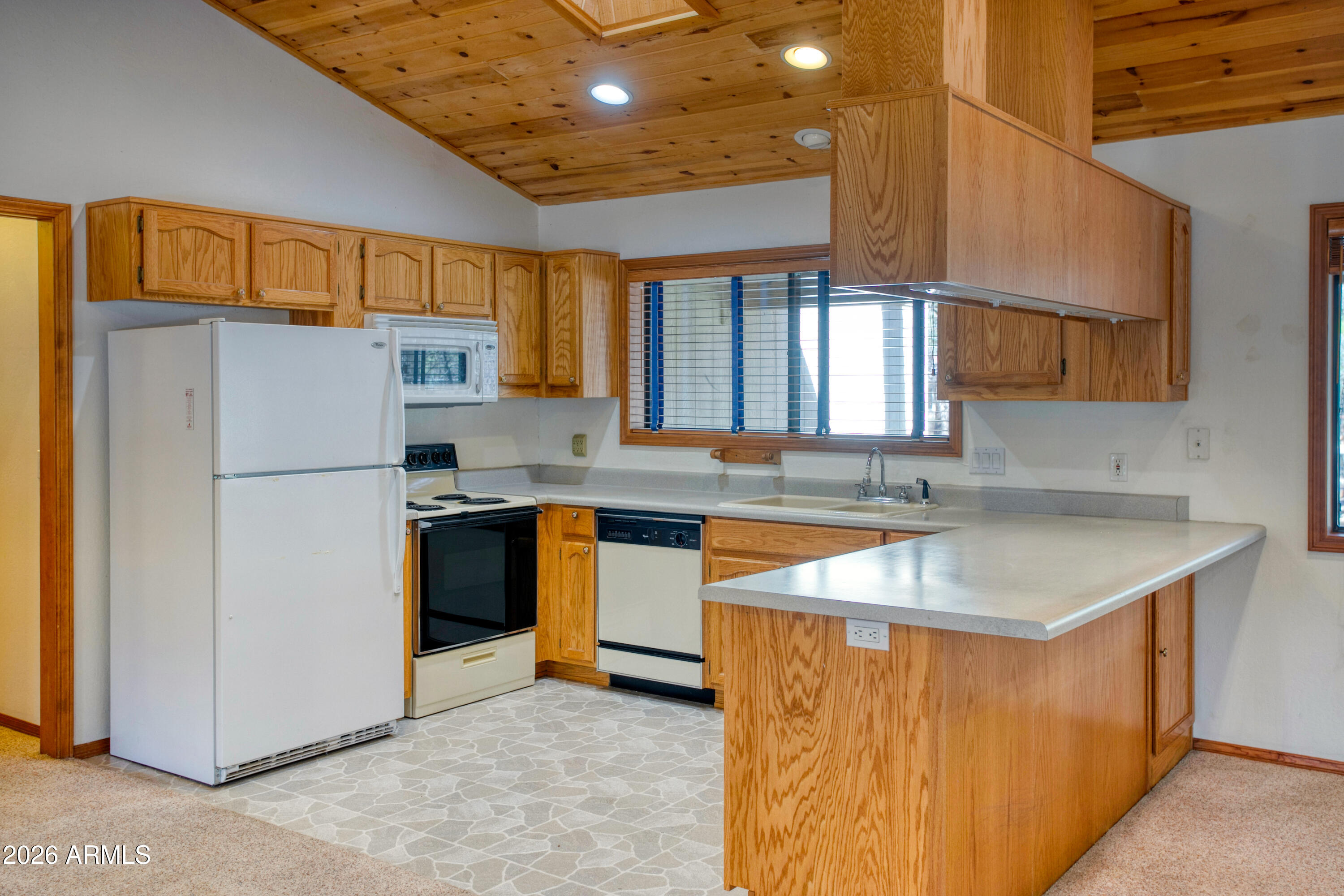 71 East Turkey Track Lane Pinetop, AZ 85935 - Photo 8 of 50 a kitchen with stainless steel appliances granite countertop a refrigerator a sink dishwasher a stove with white cabinets and countertops