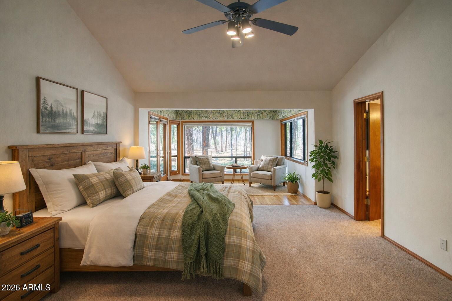 71 East Turkey Track Lane Pinetop, AZ 85935 - Photo 9 of 50 a bedroom with a large bed and a chandelier