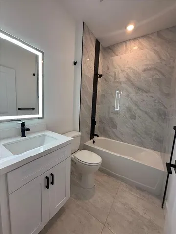 an empty room with a window and a ceiling fan