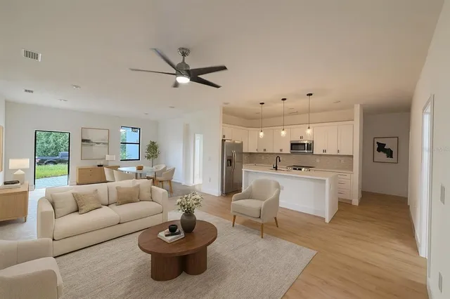 a living room with furniture and view of kitchen