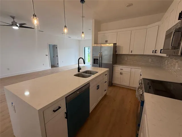 a kitchen with refrigerator cabinets and a sink