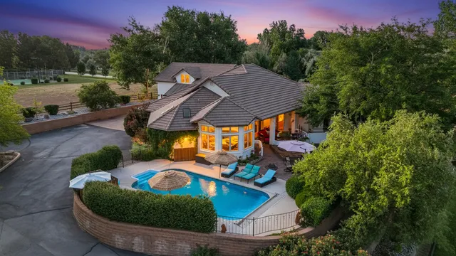 a view of a house with a yard and garage
