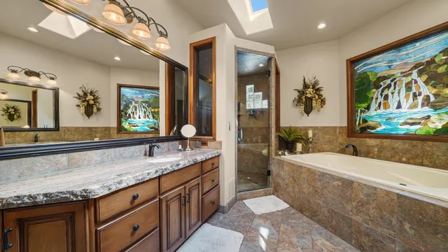 a bathroom with a granite countertop toilet a sink and a mirror