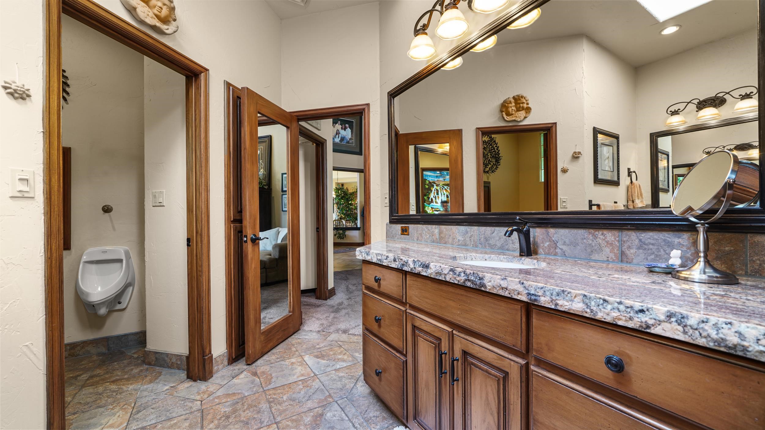 815 25 Road Grand Junction, CO 81505 - Photo 21 of 42 a bathroom with a granite countertop sink and a mirror