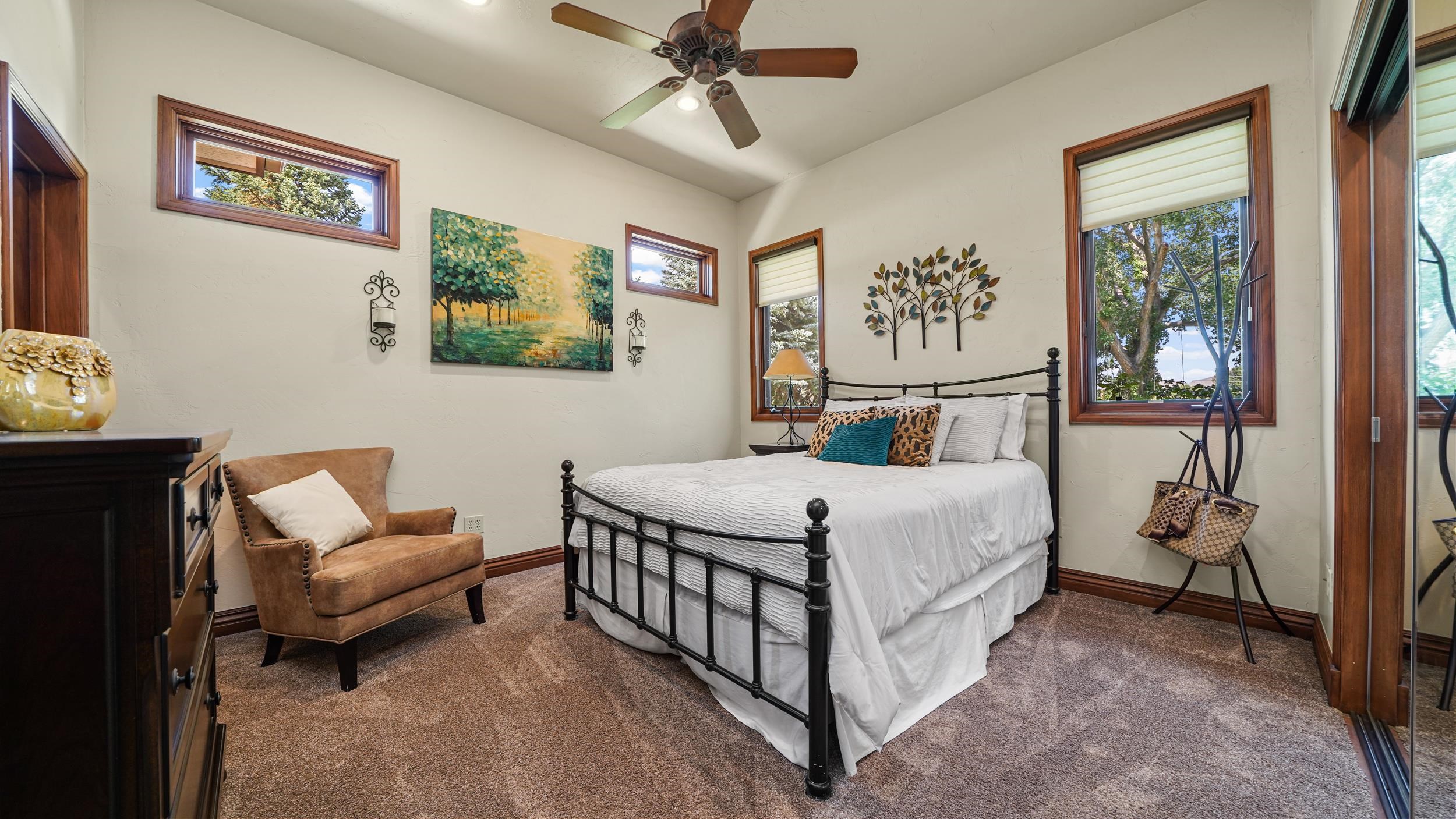 815 25 Road Grand Junction, CO 81505 - Photo 23 of 42 a bedroom with a bed and a chandelier