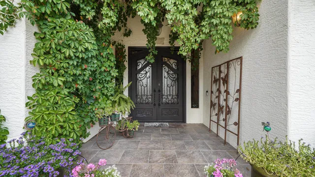 a living room with furniture a dining table a chandelier and a view of kitchen