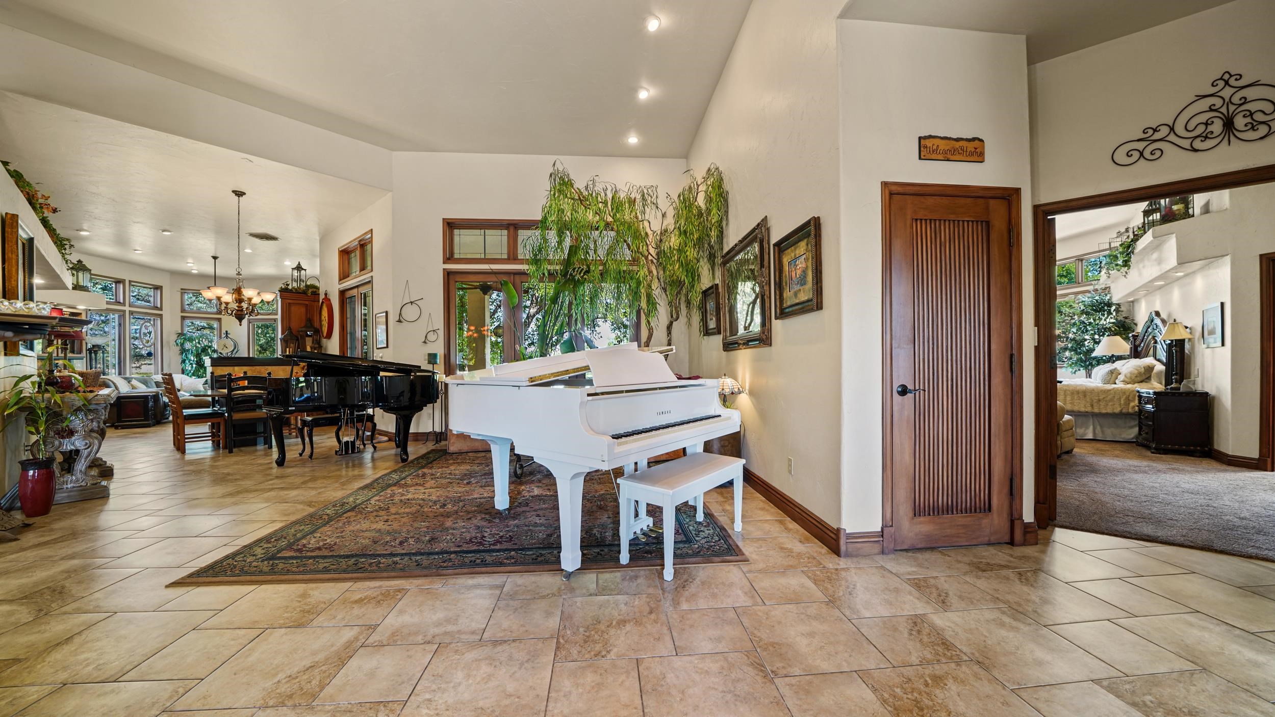 815 25 Road Grand Junction, CO 81505 - Photo 7 of 42 a living room with furniture a dining table and a potted plant