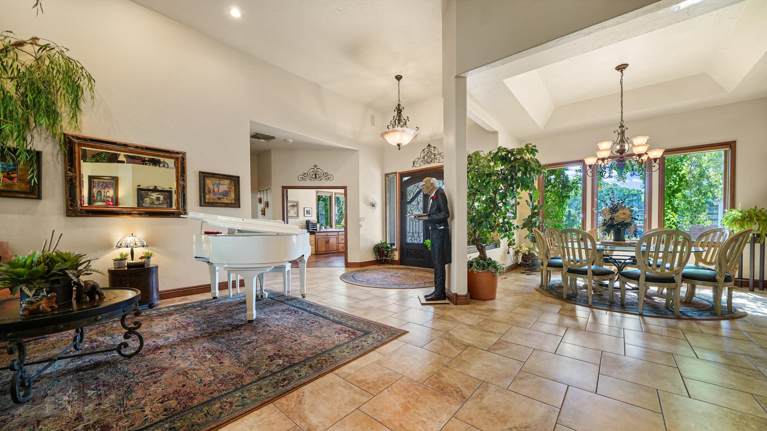 815 25 Road Grand Junction, CO 81505 - Photo 8 of 42 a living room with furniture a dining table a chandelier and a view of kitchen