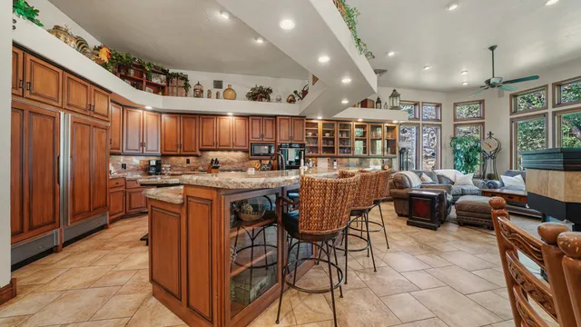 a kitchen with stainless steel appliances granite countertop a sink a stove and a refrigerator