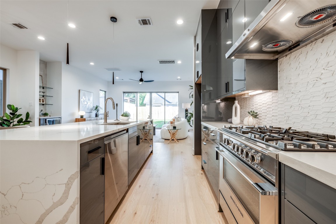 2630 Peckham Street Houston, TX 77098 - Photo 27 of 50 a large kitchen with stainless steel appliances granite countertop a lot of counter space and a sink