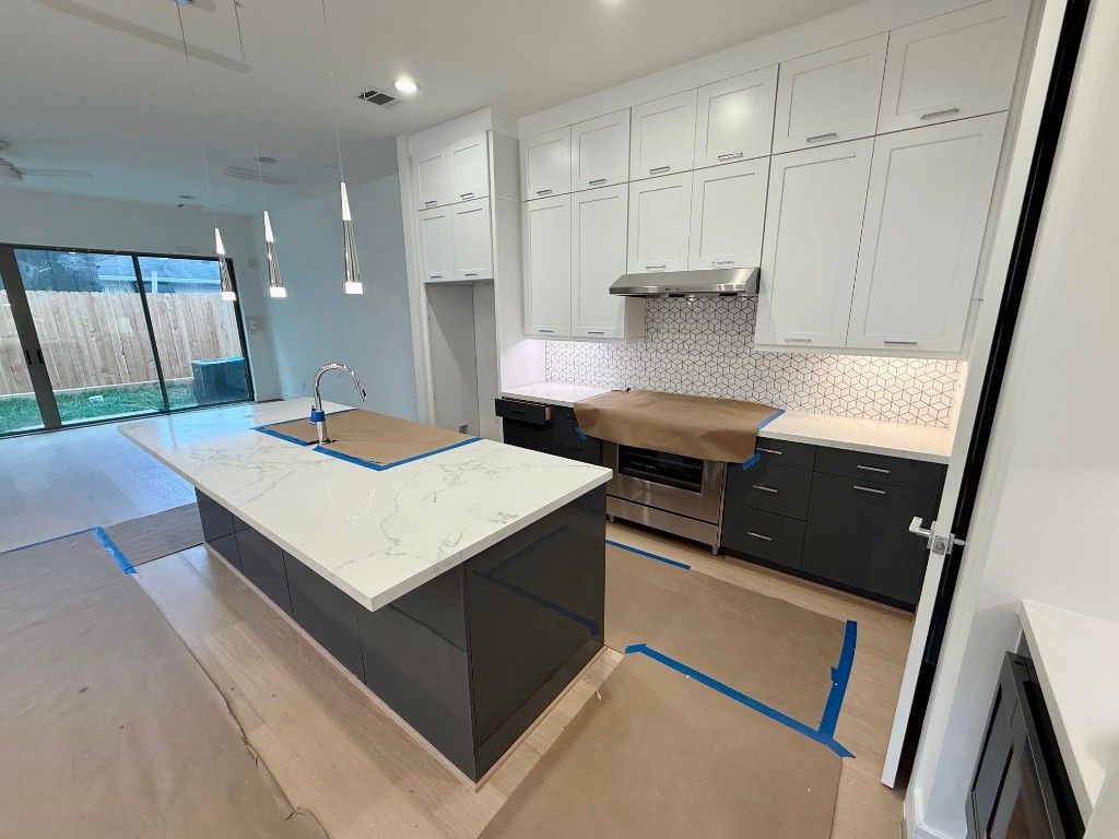 2630 Peckham Street Houston, TX 77098 - Photo 6 of 50 a kitchen with stainless steel appliances sink stove microwave and cabinets