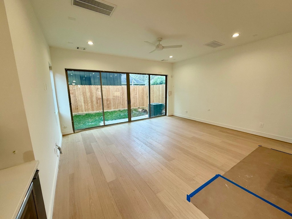 2630 Peckham Street Houston, TX 77098 - Photo 8 of 50 an empty room with wooden floor and windows