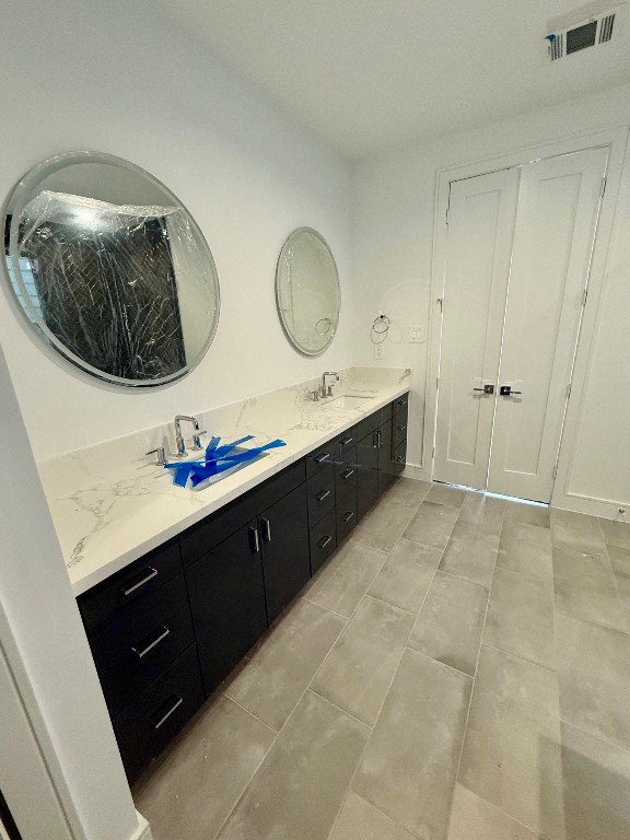 2630 Peckham Street Houston, TX 77098 - Photo 10 of 50 a bathroom with a double vanity sink and mirror