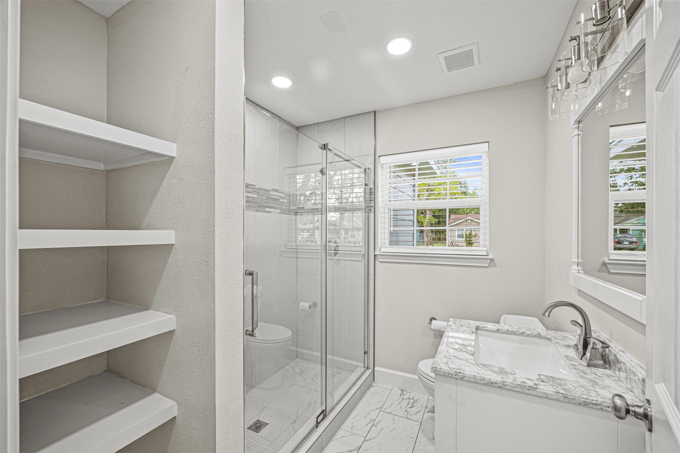 702 Norell Street Channelview, TX 77530 - Photo 13 of 16 a bathroom with a granite countertop sink toilet and shower