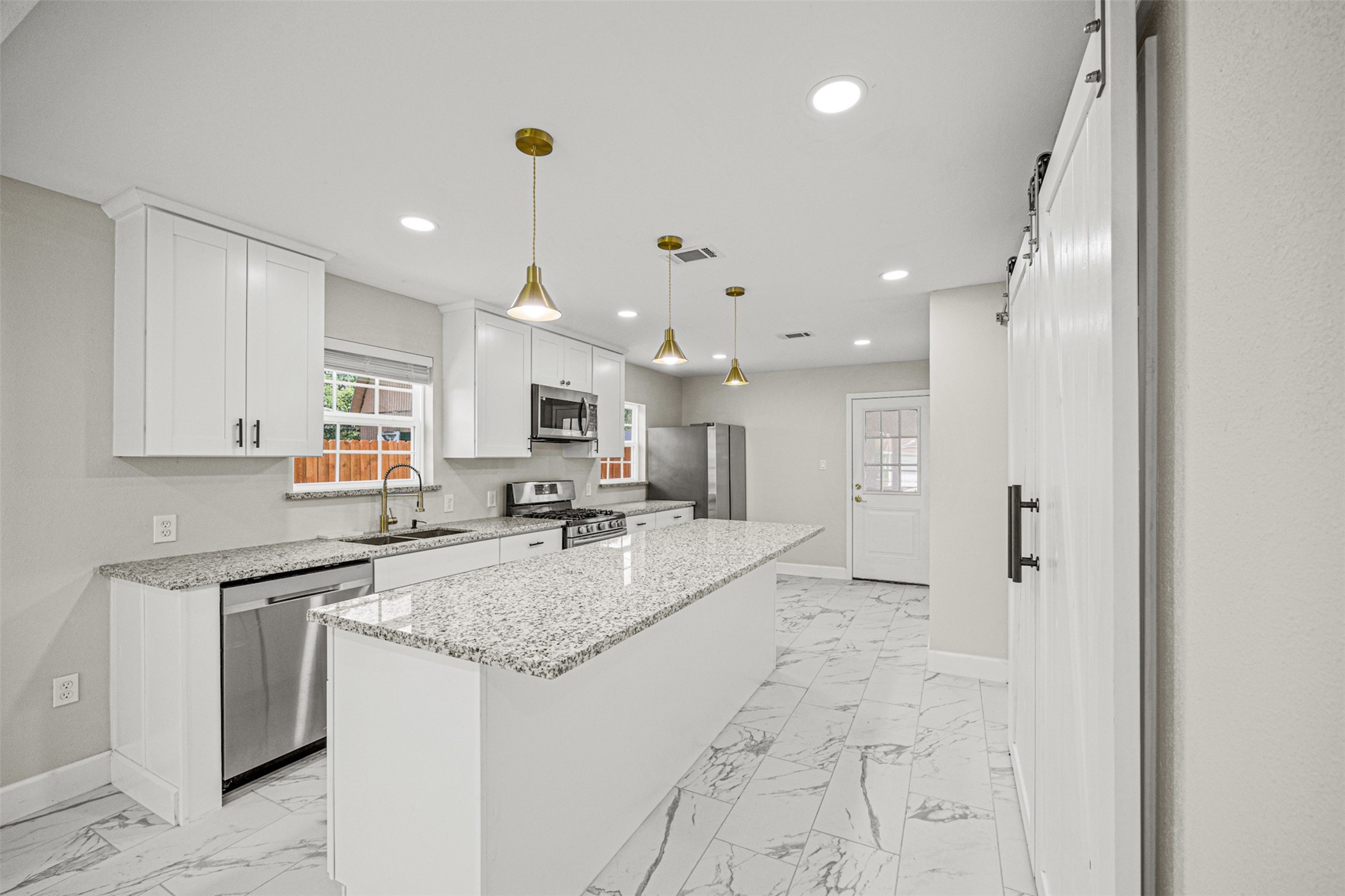 702 Norell Street Channelview, TX 77530 - Photo 2 of 16 a large kitchen with kitchen island a sink stainless steel appliances and cabinets